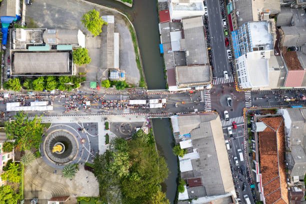 Aerial view Drone flying over phuket city Thailand.Drone over a street night market in Sunday at Phuket Town and Tourists walking shopping at old street full of local vendors selling Food and Clothes stock photo