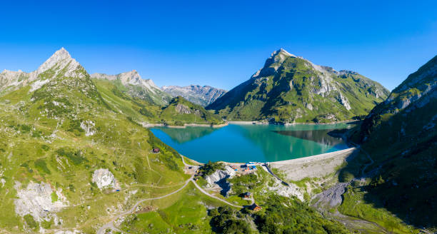 Aerial view from the Spullersee reservoir Aerial view from the Spullersee reservoir and the Lech valley in Vorarlberg, Austria. HDR panorama with extremely high resolution shot by a drone. lechtal alps stock pictures, royalty-free photos & images