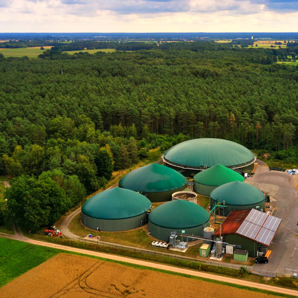 Aerial view of a biogas plant with silage piles and digesters for the production of methane gas stock photo