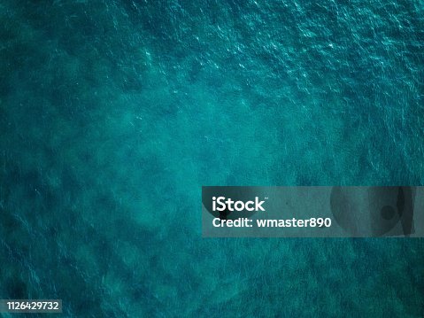 istock Aerial view of blue sea surface 1126429732