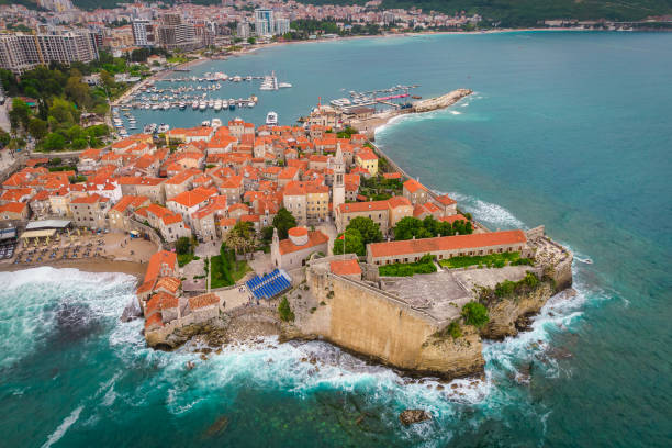 Aerial view of Budva old town with mighty sea waves stock photo