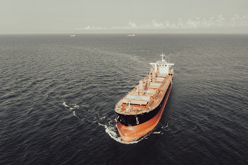 Aerial view of cargo ship entering to an international port.