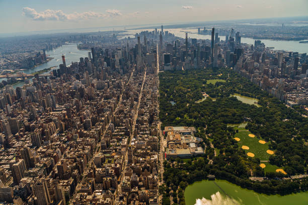 Aerial view of Central Park, Manhattan, and Lower Manhattan and Downtown Financial District in a distance behind, from a helicopter on a sunny summer day. stock photo