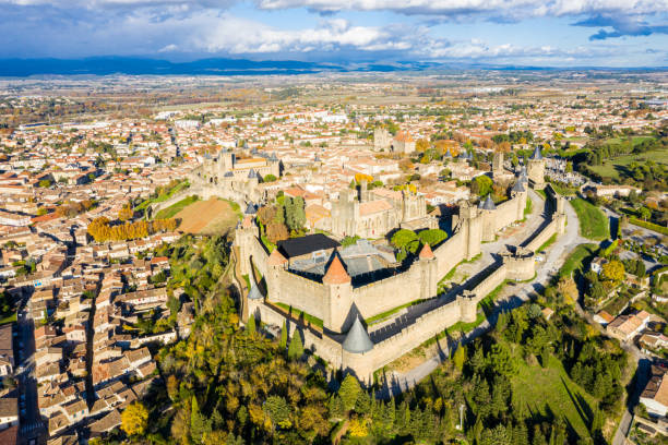 Aerial view of Cite de Carcassonne, a medieval hilltop citadel in the French city of Carcassonne, Aude, Occitanie, France. Founded in the Gallo-Roman period, the town is fortified by two castle walls stock photo