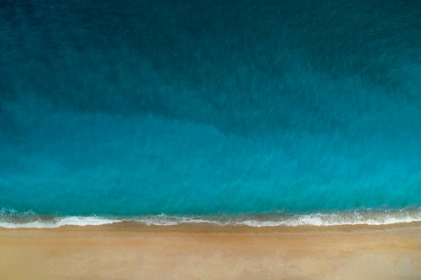 luchtfoto van helder turquoise zee en golven - navagio beach stockfoto's en -beelden