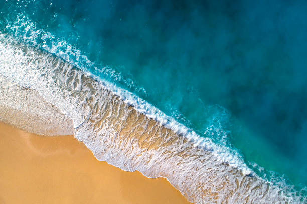 luchtfoto van helder turquoise zee en golven - navagio beach stockfoto's en -beelden