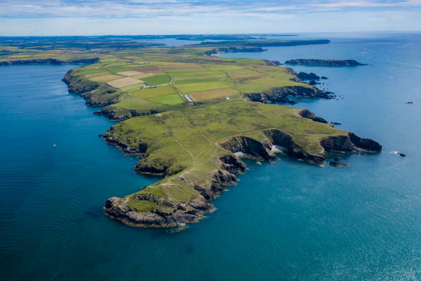Aerial view of cliffs and coastline Aerial view of a rugged ocean coastline (West Wales, Pembroke, UK) peninsula stock pictures, royalty-free photos & images