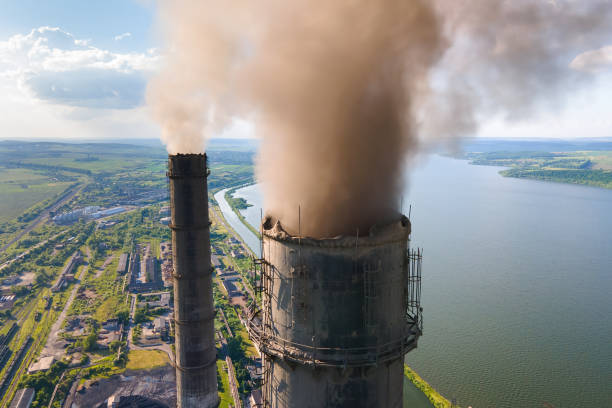 Aerial view of coal power plant high pipes with black smokestack polluting atmosphere. Electricity production with fossil fuel concept. stock photo