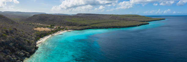 Aerial view of coast of Curaçao in the Caribbean Sea with turquoise water, cliff, beach and beautiful coral reef stock photo
