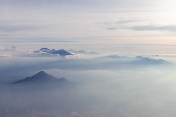 Aerial view of different volcanoes on Java Island. The fog adds to a mystical appearance of these sleeping beauties. Aerial view of different volcanoes on Java Island. The fog adds to a mystical appearance of these sleeping beauties. ::::: asian beauties : stock pictures, royalty-free photos & images