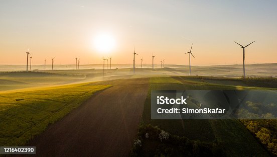 istock Aerial view of fields and wind turbines at sunrise, Austria 1216402390