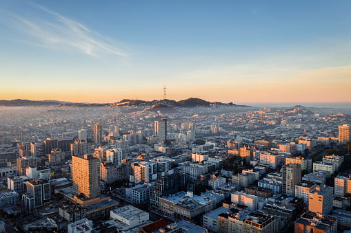 Aerial view of golden sunrise with fog over the city San Francisco looking at Sutro Tower.