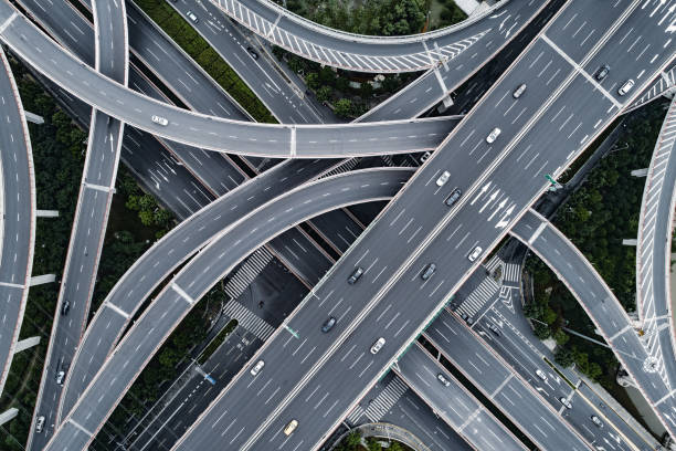 aerial view of highway and overpass in city - highway imagens e fotografias de stock