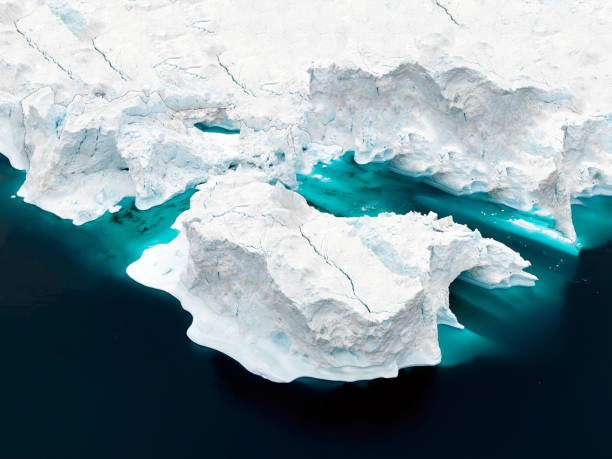 Aerial view of icebergs on Arctic Ocean in Greenland Arctic Icebergs Greenland in the arctic sea. You can easily see that iceberg is over the water surface, and below the water surface. Sometimes unbelievable that 90% of an iceberg is under water greenland stock pictures, royalty-free photos & images