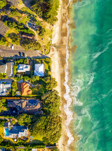 A view of beachside homes in the Takapuna district of Auckland, New Zealand from directly above the beach.