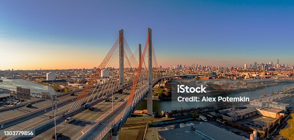 istock Aerial view of Kosciuszko Bridge surrounding with the industrial district of Williamsburg, with the remote view of Manhattan in the backdrop, in the early sunny morning. Extra-large high-resolution stitched panorama. 1303779856