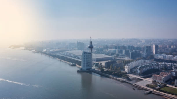 Aerial view of Lisbon and Vasco da Gama Tower, early morning with a haze of fog. stock photo