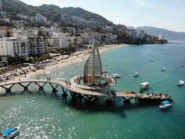 Aerial view of "Los muertos" pier. Puerto Vallarta - 1 Iconic pier of Puerto Vallarta that possess a modern architecture, symbol of the Mexican tourism. puerto vallarta stock pictures, royalty-free photos & images