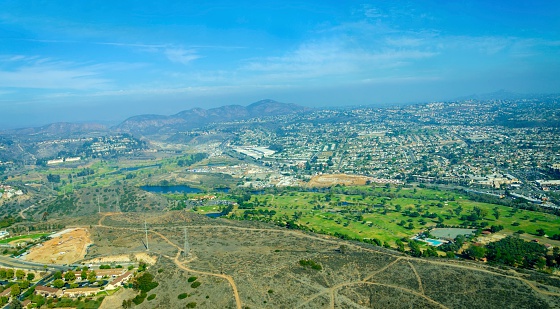 Aerial view of Mission Valley neighborhood, San Diego in Southern California, United States of America. A wide river valley trending east-west in San Diego, through which the river flows to the Pacific Ocean.