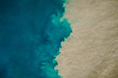 istock Aerial view of mixing blue and dirty ocean water. Natural abstract background 1370918107