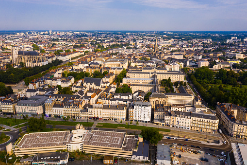 Panoramic aerial view of modern cityscape of Nantes on banks of Loire river on summer day, France