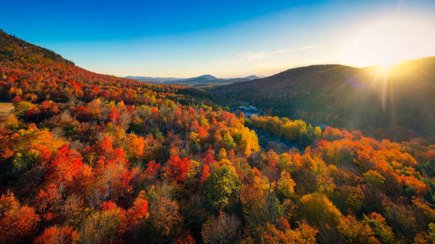 Aerial view of Mountain Forests with Brilliant Fall Colors in Autumn at Sunrise, New England Aerial view of Mountain Forests with Brilliant Fall Colors in Autumn at Sunrise, Adirondacks, New York, New England autumn leaf color stock pictures, royalty-free photos & images