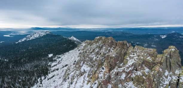 Aerial view of mountain range in winter day, drone moves forward stock photo