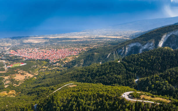 Aerial view of mountains, road to Mount Olympus. Green forest, blue sky. Litochoro city on background Aerial view of mountains, road to Mount Olympus. Green forest, blue sky. Litochoro city on background mt olympus stock pictures, royalty-free photos & images