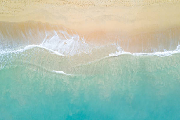 Aerial view of ocean wave reaching the coastline stock photo