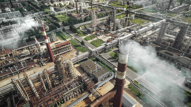 Aerial view of oil refinery plant Aerial view of oil refinery plant with smokestacks and tanks oil refinery stock pictures, royalty-free photos & images