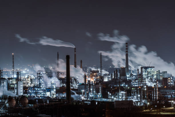 Aerial View of Petrochemical Plant and Oil Refinery Industry at Night Aerial View of Piping and Tanks of Industrial Factory at Night oil refinery factory stock pictures, royalty-free photos & images