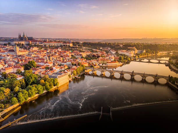 Aerial view of Prague Castle, cathedral and Charles Bridge at sunrise in Prague Aerial view of Prague Castle, cathedral and Charles Bridge at sunrise in Prague vltava river stock pictures, royalty-free photos & images