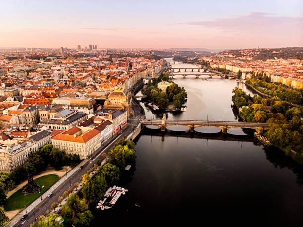 Aerial view of Prague with Vltava river at sunrise during summer Aerial view of Prague with Vltava river at sunrise during summer vltava river stock pictures, royalty-free photos & images