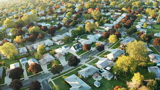 Aerial view of residential houses at autumn (october). American neighborhood, suburb. Real estate, drone shots, sunset, sunny morning,  sunlight, from above