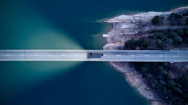 Aerial View of road above a lake Aerial View of road above a lake overpass road stock pictures, royalty-free photos & images