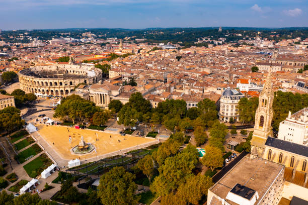Aerial view of Roman amphitheatre on background with cityscape of Nimes stock photo