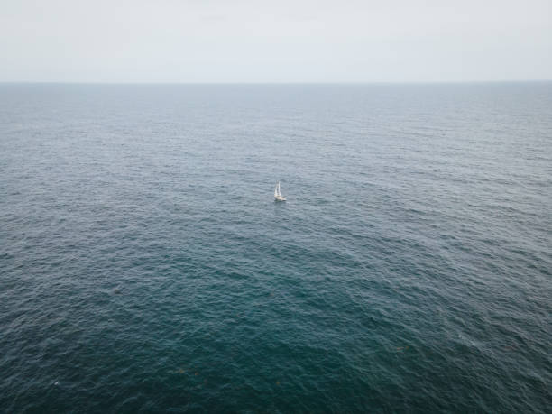 Aerial View of Sailboat Sailing off the Coast of Maine stock photo