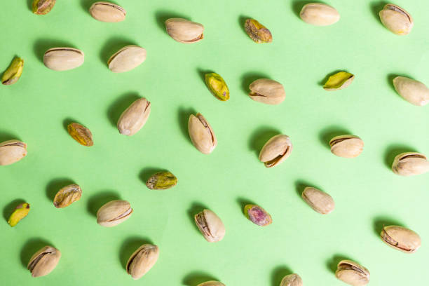 Aerial view of some pistachios on green background Aerial view of some pistachios on green background
Nuts, pistachios with and without shell pistachio stock pictures, royalty-free photos & images
