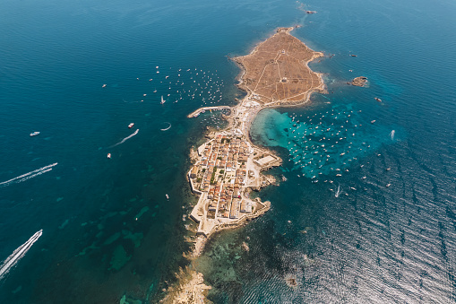 Aerial view of Tabarca island with boats at anchor. Mediterranean Sea. Popular travel destinations at summer. Spain.