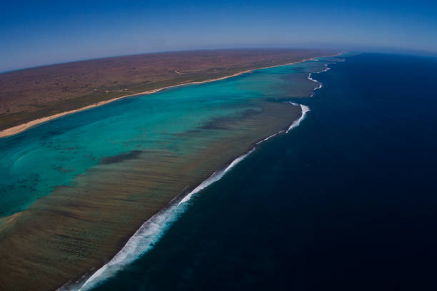 Aerial view of the amazing Cape Range National Park, the coral reef and white sand formations of the Ningaloo Marine Park and the deep blue ocean beyond stock photo