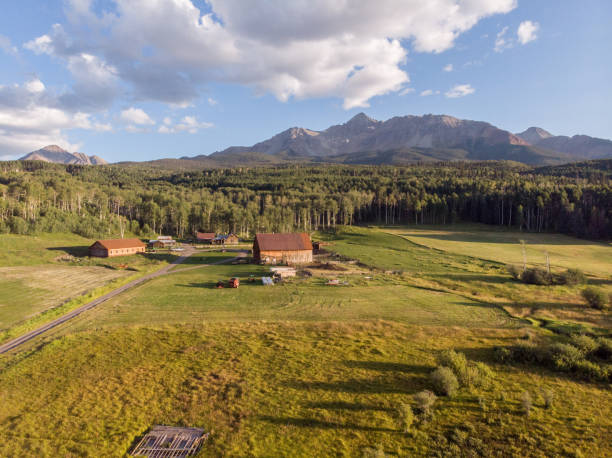 Aerial View of the famous Schmid family ranch near Mt. Wilson and Telluride Colorado on a partly sunny day in the summer under a dramatic cloudscape sky stock photo