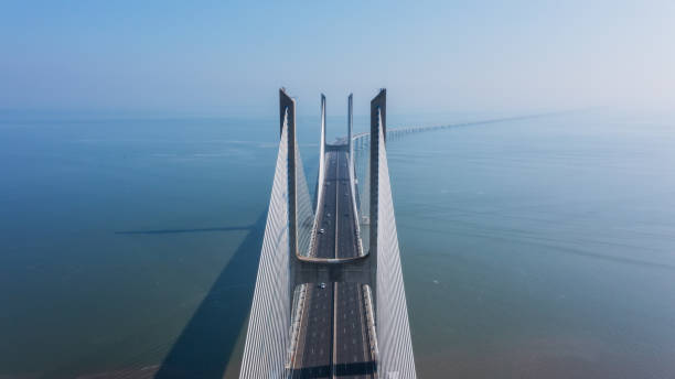 Aerial view of the most beautiful Portuguese bridge in Lisbon, Vasco da Gama. Morning foggy seascape. stock photo