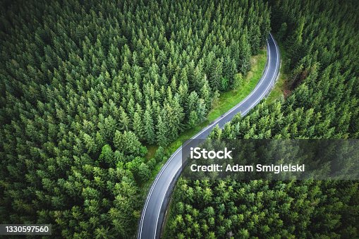 istock aerial view of the mountain road in a green forest 1330597560