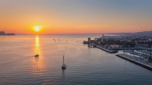 Aerial view of the Portuguese Historical Folk Patrimony, Belem Tower, on the Tagus River. During sunset. stock photo