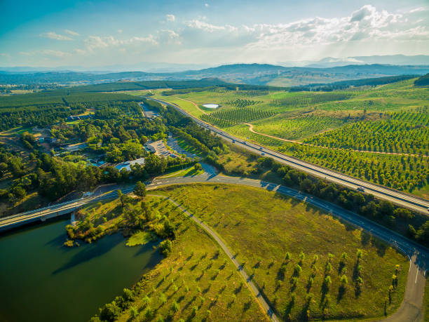 Aerial view of Tuggeranong Parkway passing near National Arboretum in Canberra, Australia Aerial view of Tuggeranong Parkway passing near National Arboretum in Canberra, Australia arboretum stock pictures, royalty-free photos & images