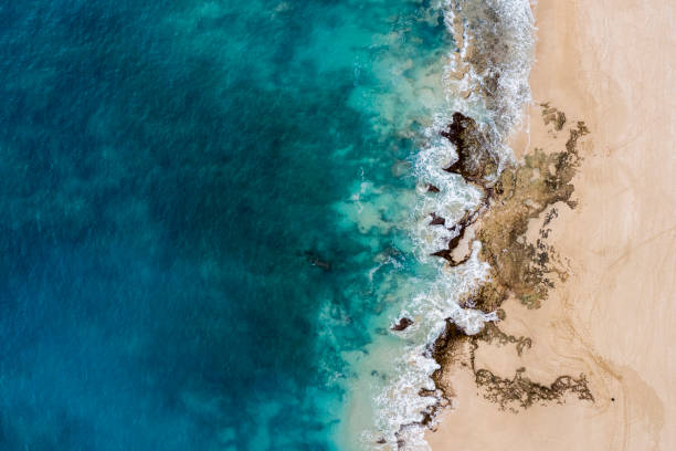 Aerial view of turquoise ocean and coral rocks in Hawaii stock photo