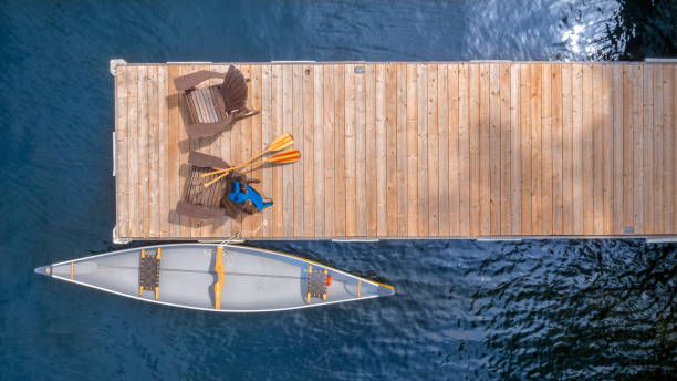 Aerial view of two Adirondack chairs on a wooden dock stock photo