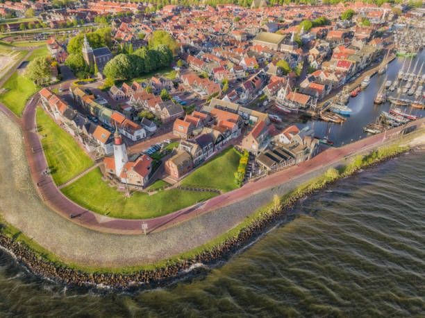 Aerial view of Urk with its lighthouse, a small coastal village on the IJsselmeer in the Netherlands. Aerial view of Urk with its lighthouse, a small coastal village on the IJsselmeer in the Netherlands. flevoland stock pictures, royalty-free photos & images