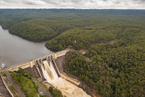 Aerial view of Warragamba Dam in outer South Western Sydney suburb of Warragamba, Wollondilly Shire, spilling water into Warragamba River during the heavy rain period of March 2022