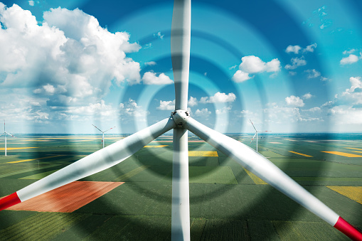 Aerial view of wind turbines on modern wind farm from drone pov, digitally enhanced image high angle view of innovative sustainable resources technology